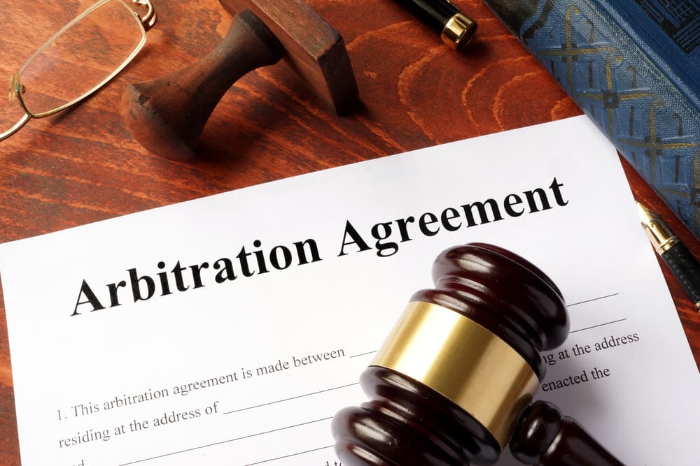 Arbitration agreement resolution of commercial disputes on a desk.