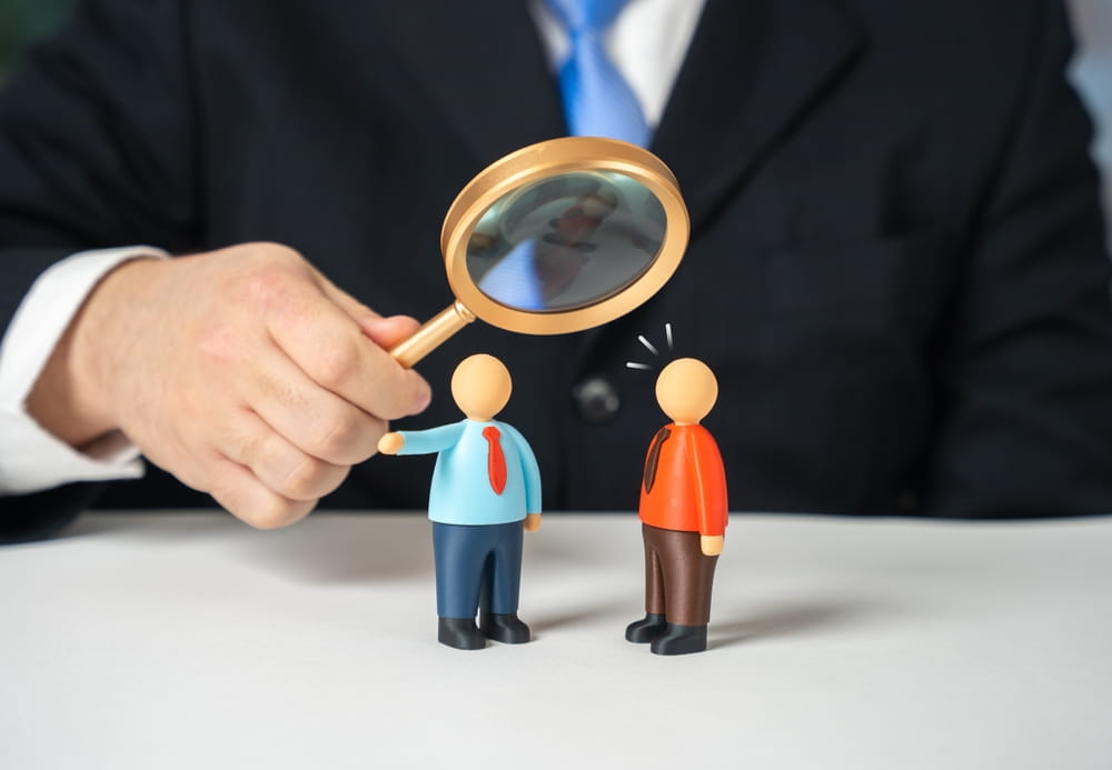 Magnifying glass examining figures representing dispute resolution process in Washington State